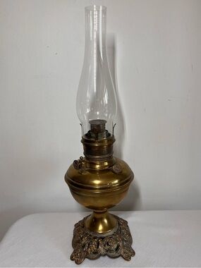 Vintage brass kerosene oil lamp, 1910, ornate cast iron base, glass chimney, USA
